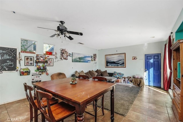 dining room featuring ceiling fan and tile patterned floors