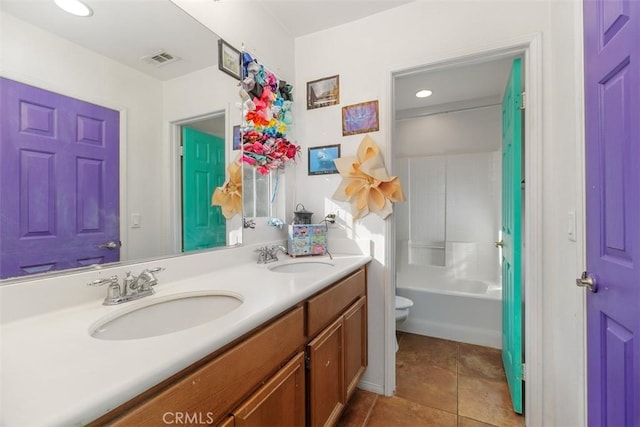 full bathroom featuring toilet, vanity, tile patterned flooring, and bathtub / shower combination