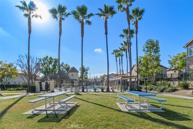 surrounding community featuring a lawn and a swimming pool