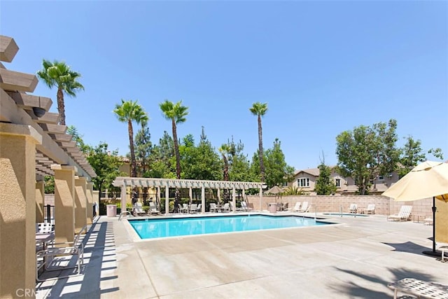 view of swimming pool featuring a patio and a pergola