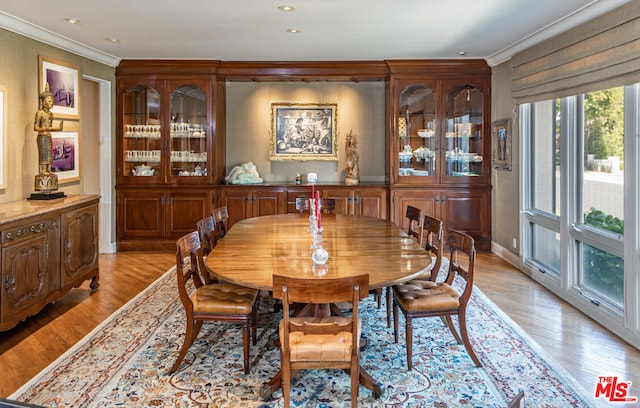 dining room featuring ornamental molding and light hardwood / wood-style floors