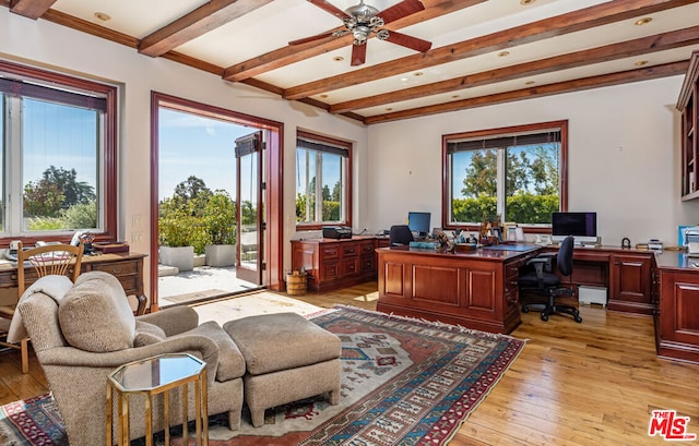 office space with ceiling fan, beamed ceiling, and light hardwood / wood-style floors