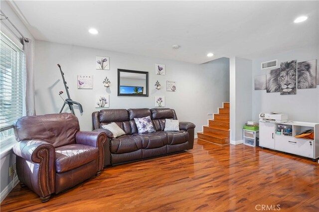 living room featuring a wealth of natural light and hardwood / wood-style flooring