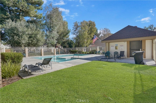 view of swimming pool featuring a lawn and a patio area