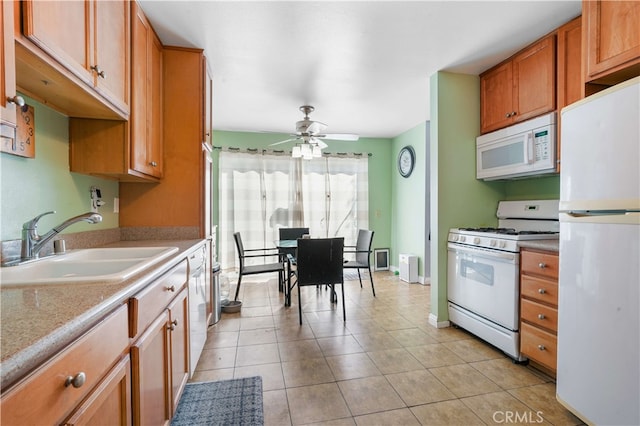 kitchen with ceiling fan, light tile patterned floors, sink, and white appliances