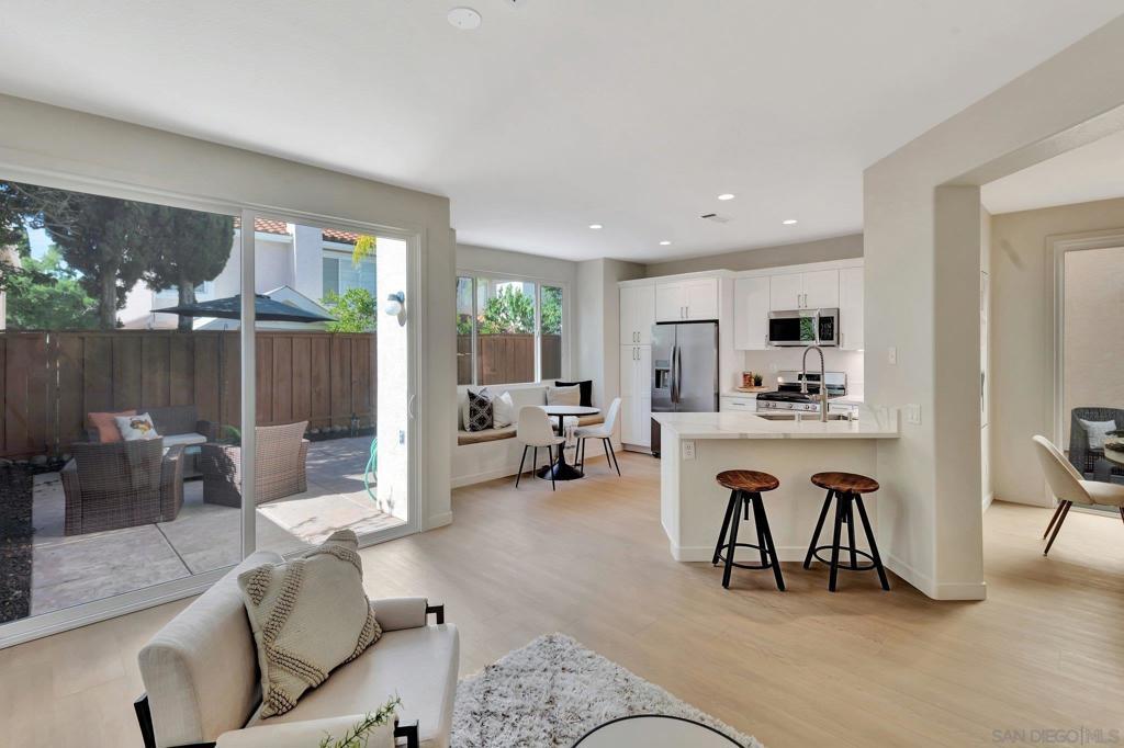 living room with light hardwood / wood-style flooring and sink