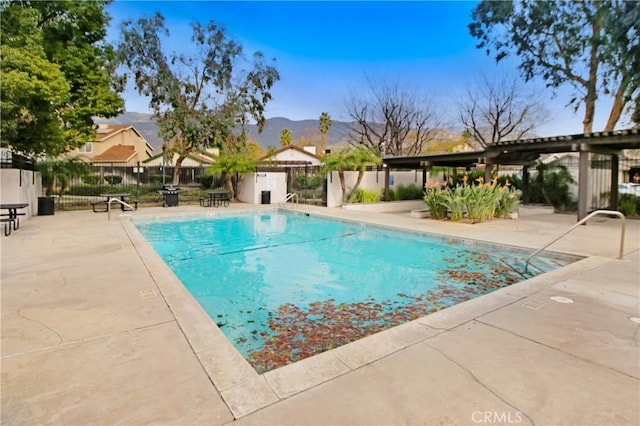 view of swimming pool featuring a mountain view and a patio area