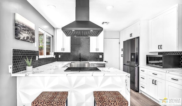 kitchen with white cabinets, sink, appliances with stainless steel finishes, and island exhaust hood