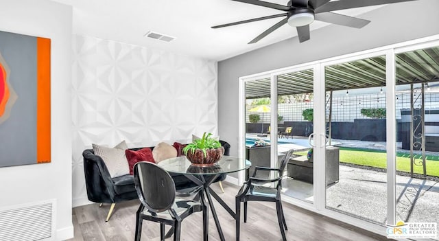 dining space featuring ceiling fan and wood-type flooring