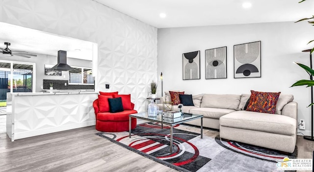 living room featuring ceiling fan, vaulted ceiling, and hardwood / wood-style flooring