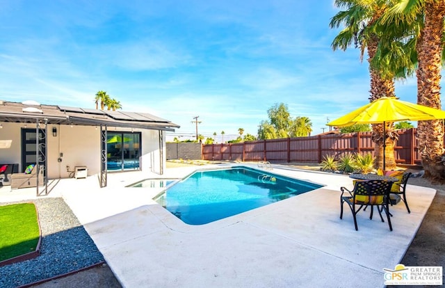 view of swimming pool with a patio area