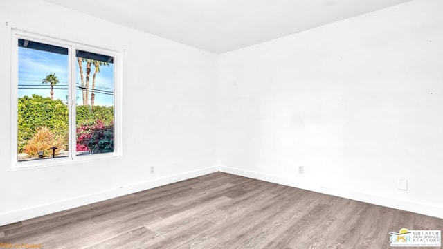 unfurnished room with hardwood / wood-style floors