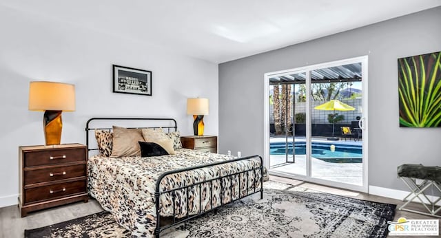 bedroom with access to exterior and light hardwood / wood-style flooring