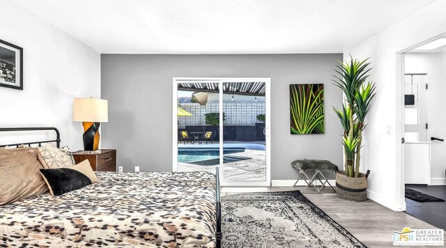 bedroom featuring hardwood / wood-style flooring and access to outside