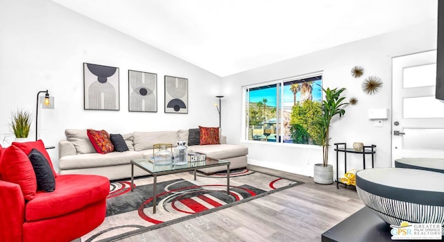 living room with vaulted ceiling and hardwood / wood-style flooring