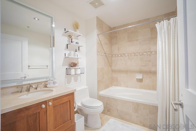 full bathroom featuring tile patterned flooring, toilet, vanity, and shower / bath combination with curtain