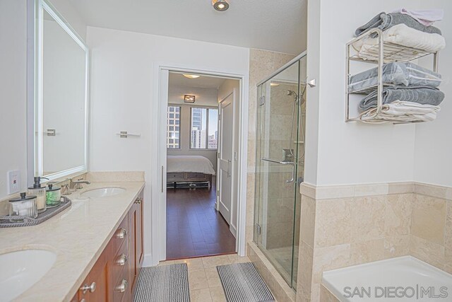 bathroom with vanity, tile patterned floors, and shower with separate bathtub