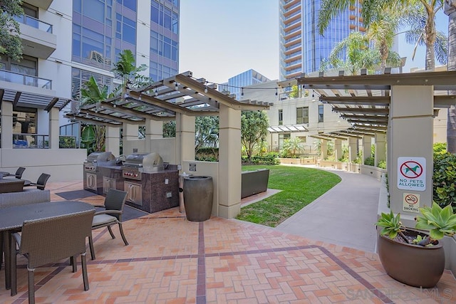 view of patio with a pergola and area for grilling