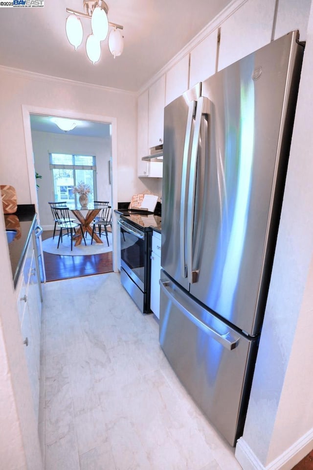 kitchen with appliances with stainless steel finishes, ornamental molding, and white cabinetry