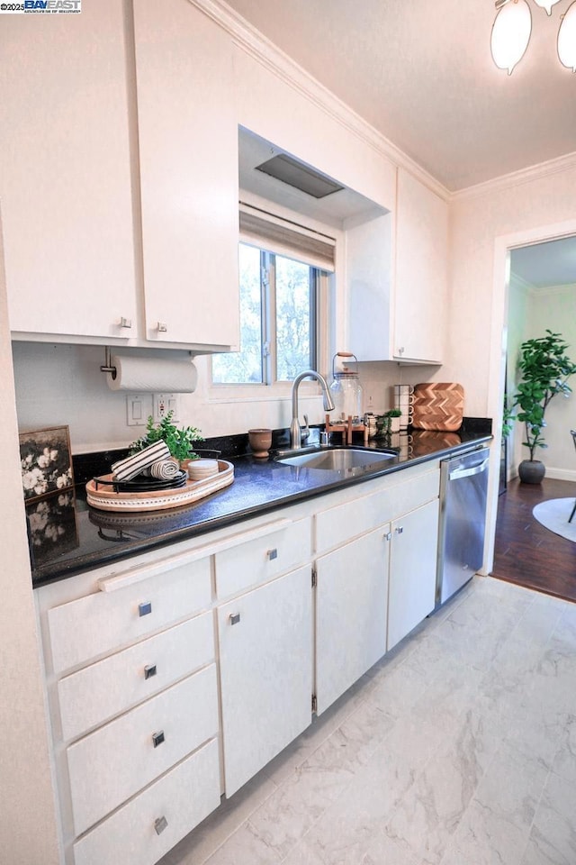 kitchen featuring sink, white cabinetry, stainless steel dishwasher, and crown molding