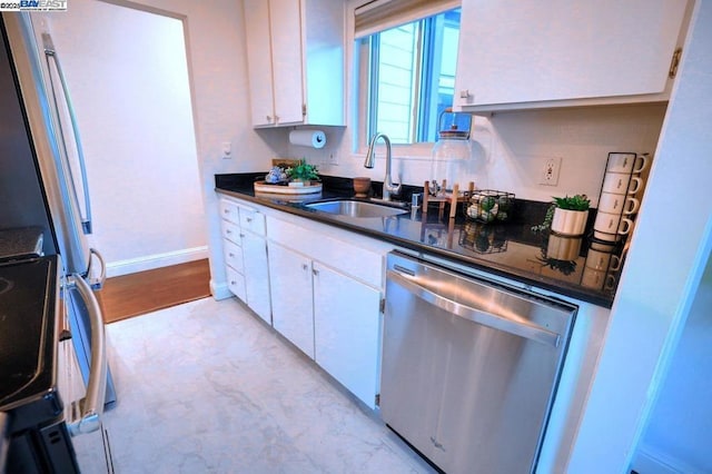 kitchen with white cabinetry, stainless steel dishwasher, and sink