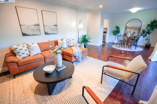 living room featuring dark hardwood / wood-style flooring and ornamental molding