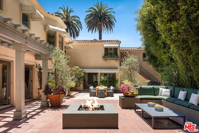 view of patio / terrace with an outdoor living space with a fire pit