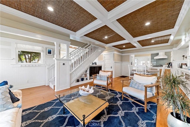 living room with hardwood / wood-style flooring, ornamental molding, coffered ceiling, and beamed ceiling