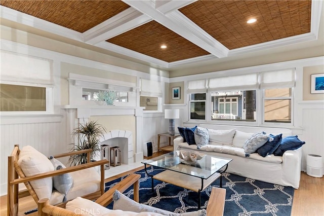 living room with hardwood / wood-style floors, coffered ceiling, wooden ceiling, ornamental molding, and beamed ceiling