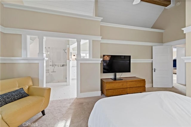 bedroom with ensuite bath, light colored carpet, ceiling fan, and high vaulted ceiling