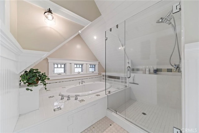 bathroom with plus walk in shower, lofted ceiling, and tile patterned floors