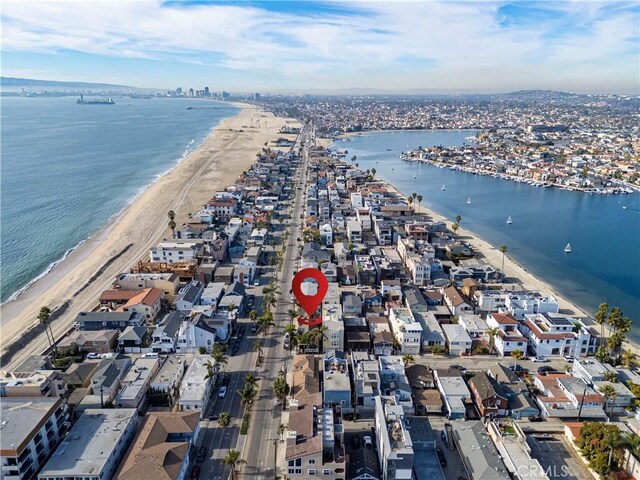 bird's eye view featuring a water view and a view of the beach