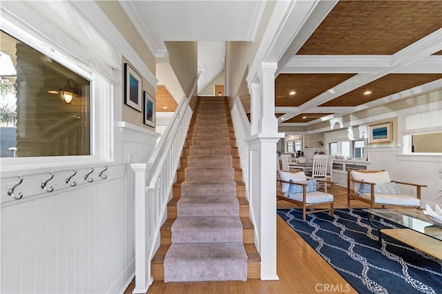 staircase with hardwood / wood-style floors, ornamental molding, beam ceiling, and coffered ceiling