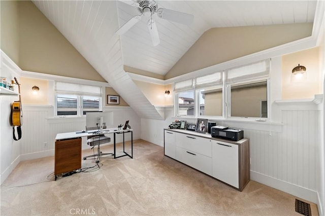 home office featuring vaulted ceiling, ceiling fan, and light colored carpet