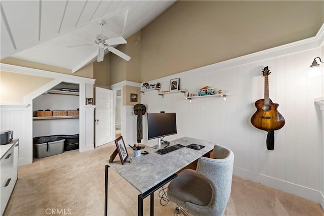 carpeted office with ceiling fan and vaulted ceiling