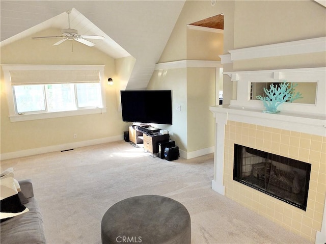 living room featuring lofted ceiling, light colored carpet, ceiling fan, and a fireplace