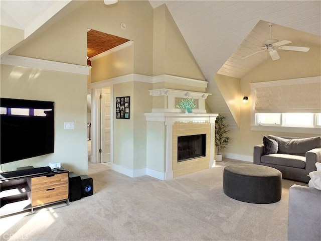 carpeted living room featuring ceiling fan, a tiled fireplace, and high vaulted ceiling