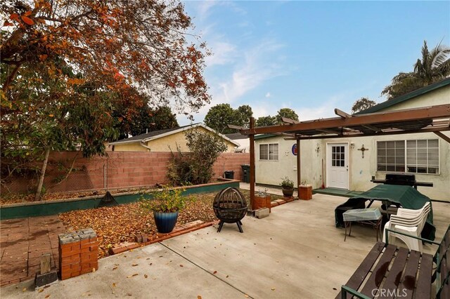 view of patio / terrace featuring an outdoor fire pit