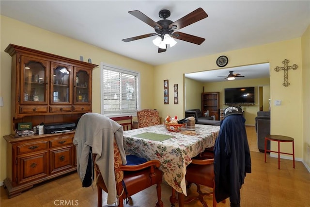 dining room with ceiling fan and light wood-type flooring