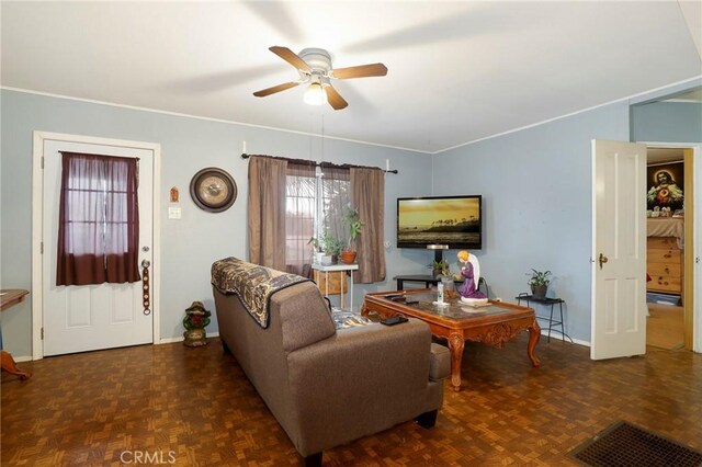 living room featuring dark parquet flooring and ceiling fan