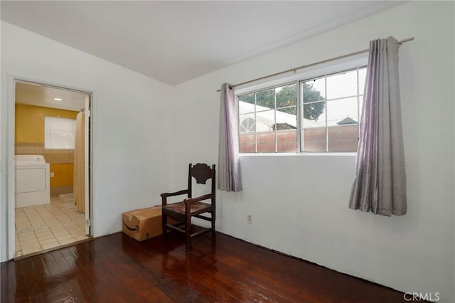 unfurnished room featuring dark hardwood / wood-style floors and washer / dryer