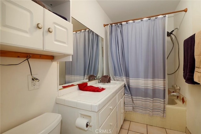 full bathroom featuring toilet, vanity, tile patterned floors, and shower / bathtub combination with curtain