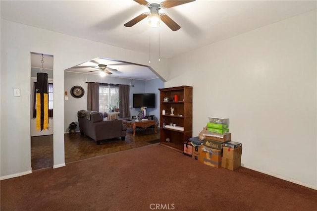 living room with ceiling fan and dark colored carpet