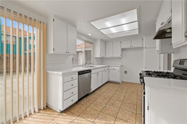 kitchen featuring dishwasher, sink, light tile patterned flooring, white cabinetry, and white range with gas stovetop