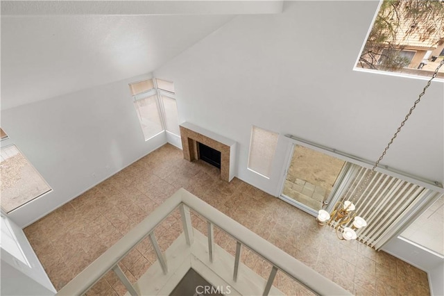 living room with vaulted ceiling and an inviting chandelier