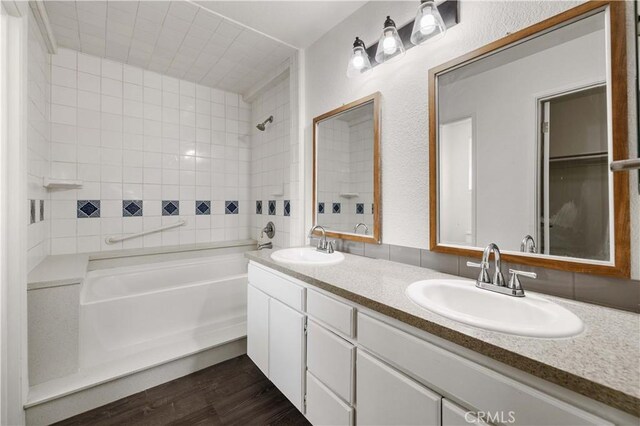 bathroom with vanity, a bathtub, and hardwood / wood-style flooring