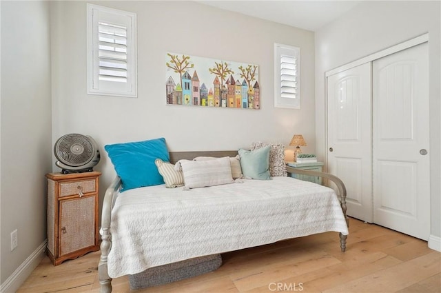 bedroom with a closet and light hardwood / wood-style floors