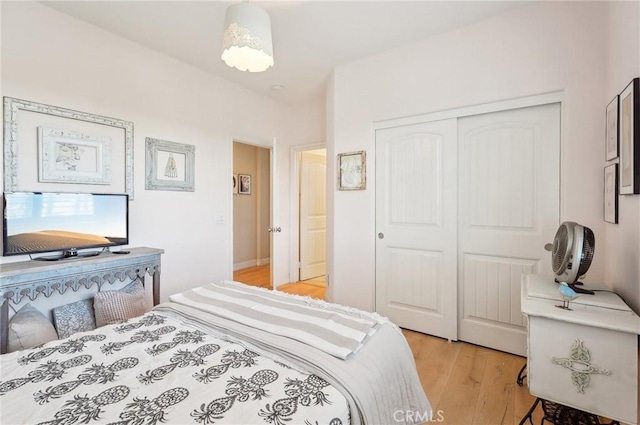 bedroom with light wood-type flooring and a closet