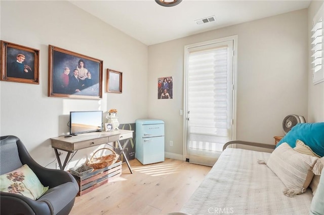 bedroom featuring light wood-type flooring and multiple windows