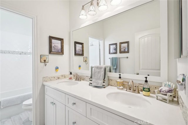 full bathroom featuring toilet, vanity, and shower / bathing tub combination